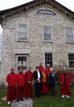 Monks in front of house with Charles